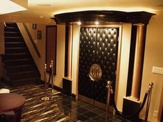 an elevator in a hotel lobby with black and gold decor