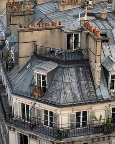 an old building with lots of windows and balconies on the top floor is seen from above