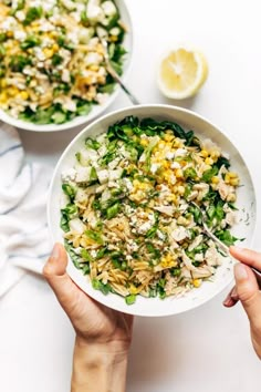 two bowls filled with salad next to each other on top of a white countertop