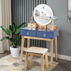 a blue vanity table with a mirror and stool in front of it on top of a rug