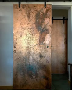 a room with two doors that have rusted metal panels on the side of it