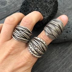 Three unique and powerful statement rings. The 3 of them are made in a braided, overlapping style that creates this unique chunky silver rings. Perfect everyday rings, that will rock your outfits, and are easy to match any other accessories. In one of the pictures, you can see which number represents each ring. Ring 1 is a size 8.5 Ring 2 is a size 8 Ring 3 is a size 8 All unique addition to your ring collection. To see more unique silver rings, click the link below https://www.etsy.com/shop/Aka Handmade Brutalist Open Ring Jewelry, Handmade Brutalist Open Ring, Unique Handmade Wide Band Rings, Unique Handmade Wide-band Rings, Handmade Adjustable Brutalist Jewelry, Handmade Unique Rings With Thick Band, Unique Handmade Rings With Thick Band, Unique Wide Band Metal Rings, Unique Handmade Wide Band Open Ring