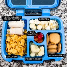 a blue lunch box filled with different types of food