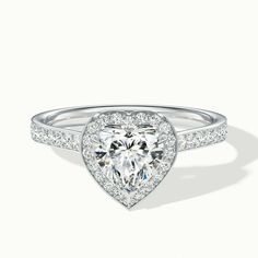 a heart shaped diamond ring with diamonds around it