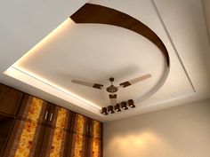 a ceiling fan mounted to the side of a bed in a bedroom