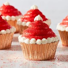 red velvet cupcakes with white frosting and sprinkles on top