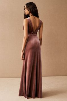 a woman in a long dress looking back