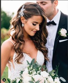 the bride and groom are standing together outside