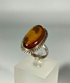 Discover the timeless elegance of our Spectacular Orange Amber Ring, expertly crafted for ladies in stunning 925 sterling silver. This exquisite piece features natural Baltic Sea amber, renowned for its unique beauty and healing properties. Perfect for any occasion, this amber ring will add a touch of sophistication to your jewelry collection. Product Details: Material: 925 Sterling Silver Stone: Natural Baltic Sea Amber Color: Spectacular Orange Design: Minimalist Style Ring Size: 7.1/4 Us size Classic White Gold Cabochon Jewelry, Wedding Jewelry Polished Oval Cabochon, Wedding Jewelry Oval Cabochon Polished Finish, Oval Cabochon Jewelry With Polished Finish For Weddings, Timeless Oval Cabochon Jewelry, Fine Jewelry Sterling Silver Ring With Polished Finish, Heirloom White Gold Cabochon Ring, Timeless Oval Sterling Silver Jewelry, Fine Jewelry White Gold Rings With Cabochon