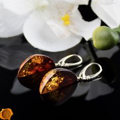 "\"Shoot for the Amber Moon. Even if you miss it, you will land among the stars.\" This pair of dazzling Amber Moon earrings beholds perfectly crafted cognac Baltic Amber set in 925 Hallmarked Silver. Lever-back closure ensures a secure and comfortable fit. Smooth, shiny and glossy. Handcrafted to a standard of perfection will make a meaningful nature-inspired gift or just another wonderful love token for yourself or your special someone. Presented in a luxury gift box. *Cognac Baltic Amber 40 - Gift Amber Drop Earrings, Amber Dangle Earrings For Anniversary, Amber Drop Earrings For Gift, Amber Drop Earrings For Formal Occasions, Drop Clip-on Earrings For Gift, Handmade Amber Earrings Gift, Handmade Amber Earrings For Gift, Amber Dangle Earrings As Gift, Amber Dangle Earrings For Gift