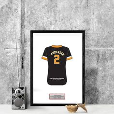 a framed black and yellow football jersey with the number 2 on it