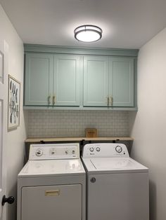 a washer and dryer sitting in a laundry room next to eachother