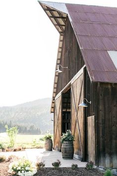 an old barn with a metal roof and door