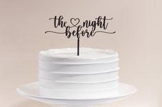 a white cake with the words the night before on it and a black topper