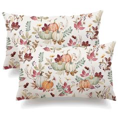 two pillow cases with pumpkins and leaves on them, one has a white background