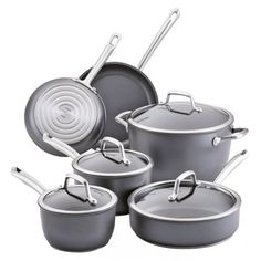 an assortment of pots and pans with lids