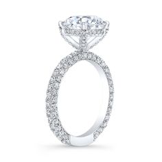 an oval shaped diamond engagement ring on a white background