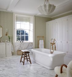 a white bath tub sitting inside of a bathroom