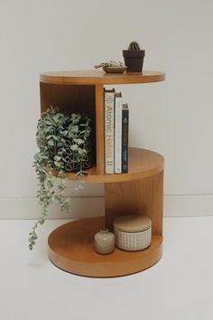 A three tiered cylindrical side table with a fun cut out design will store your favorite treasures in the most creative way. Add a plant for a touch of greenery and candles on top for a warm and calming moment. Rounded design Cut out shelf space for maximum storage Variance in wood grain Fully assembled Rounded Corner Bedside Table, Side Table Living Room, Curvy Side Table, Roubd Side Table, Electic Side Table, Bohemian Side Table Wood, Bedroom Side Table Ideas, Unusual Bedside Tables, Modern Side Table Design