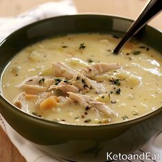 a green bowl filled with chicken and cheese soup