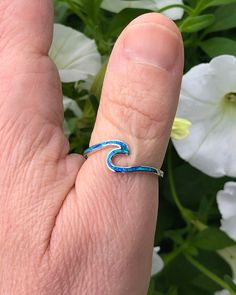 Sterling Silver Wave Ring with Blue Lab Opal | The Life Divine Keep the ocean close and go with the flow. This sterling silver Wave Ring symbolizes the ups and downs we see in life, reminding you to roll with the tides. Wear this ring as a reminder to stay positive, happy and strong regardless of what life throws your way.Cherished for its brilliance, Opal is known as a stone of creativity and vitality. Opal is also a reflective stone of protection, absorbing energies and sending them back to th Ocean-inspired Blue Ring For Gift, Ocean-inspired Blue Ring For Gifts, Ocean-inspired Blue Rings As Gifts, Minimalist Blue Jewelry For Beach, Sterling Silver Hypoallergenic Blue Rings, Minimalist Nickel-free Blue Ring, Minimalist Blue Hypoallergenic Rings, Wave Ring, Go With The Flow