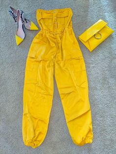 Yellow jumpsuit perfect for the Summer 🌤️! Make this a year round outfit by pairing with a blazer and ankle boots during the Fall 🍁. Trendy Strapless Jumpsuit With Pockets, Summer Utility Jumpsuits And Rompers, Trendy Strapless Jumpsuit With Pockets For Summer, Spring Yellow Jumpsuits And Rompers With Pockets, Casual Solid Strapless Jumpsuit For Night Out, Casual Yellow Jumpsuits And Rompers For Work, Fitted Strapless Jumpsuit With Pockets For Spring, Spring Overalls For Night Out, Chic Strapless Overall Jumpsuit For Day Out