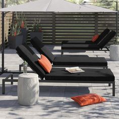 an outdoor patio with black and orange furniture