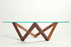 a glass and wood table with an unusual design