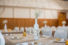 there is a vase with flowers in it on top of the table at this wedding reception