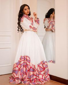 This Habesha dress is a true work of art, made of high-quality Menen fabric that is known for its elegance and beauty. The dress features stunning Mulu Tilf embroidery on the bodice and sleeves, adding a touch of sophistication and class. The tilf embroidery is done in a way that highlights the beauty of the Menen fabric, creating a stunning contrast that is both timeless and modern. The dress is designed with a flattering fit that accentuates the curves, and the flowing skirt adds a graceful to Eritrean Clothing, Eritrean Dress, African Bridal Dress, Ethiopian Clothing, Habesha Dress, Ethiopian Dress, Habesha Kemis, Traditional Dresses Designs, Cultural Events