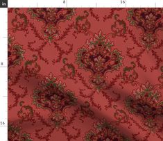 a red and green fabric with an ornate design