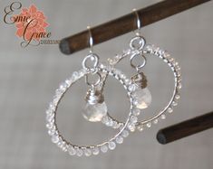 "These beautiful hoop earrings are made of sterling silver, clear quartz and pearl white chalcedony by hand with attention to detail. Would make beautiful bridal jewelry with their sparkle and shine! The large clear quartz briolettes that hang suspended at the center of the large silver hoops are a bit cloudy giving them a intentionally imperfect look that really is stunning. The pearl white chalcedony has a lovely pearly quality that really sparkles in the light. All wire, jump rings, ear wires White Wire Wrapped Small Hoop Jewelry, Handmade Clear Hoop Jewelry, Handmade Silver Crystal Hoop Earrings, Silver Round Crystal Earrings Wire Wrapped, Silver Round Crystal Earrings, Wire Wrapped, Nickel-free Clear Jewelry For Wedding, Beautiful Bridal Jewelry, Earrings Wire, Sterling Silver Bangles