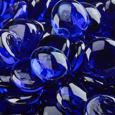 blue glass marbles are stacked together on top of each other