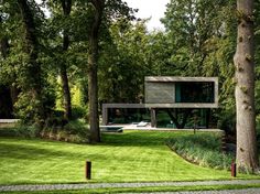 the house is surrounded by trees and grass