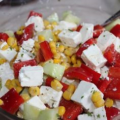 a glass bowl filled with vegetables and tofu