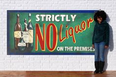 a woman standing in front of a sign that says no liquor on the premisess