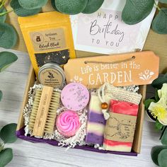 a gift box filled with soaps, shaving brush and other items