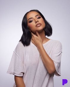 an image of a woman posing with her hand on her chin and looking at the camera