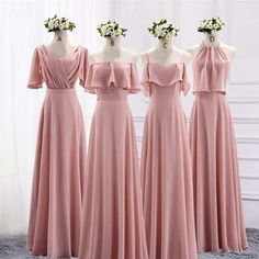 three bridesmaids in pink dresses standing next to each other with flower crowns on their heads