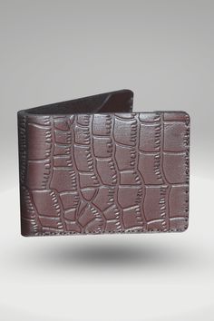 Men's Black Genuine Cowhide Leather Wallet With Crocodile Textured Finish | Bifold Hand-Made Leather Mini Wallet This Men's crocodile leather mini wallet is made with 100% vegetable-tanned cowhide leather. This hand-stitch product is equipped with crocodile texture and a soft glossy finish, giving it a luxurious feel. Its two cash slots and two card pockets allow you to store your essentials securely and quickly in one place. This genuine leather wallet will make a beautiful addition to your everyday carry! Style: Bi-Fold Mini Wallet Made: Hand-stitched using waxed polyamide thread Leather: 100% Vegetable Tanned Cowhide leather With Crocodile Textured Finish OuterShell Color: Black InnerShell Color: Black Thread: Black Closure: Bi-fold Feature: Crocodile Texture With Soft Glossy Finish Out Business Wallets With Crocodile Pattern, Business Wallets With Crocodile Pattern In Rectangular Shape, Rectangular Business Wallet With Crocodile Pattern, Business Wallet With Crocodile Pattern, Leather Wallet With Crocodile Pattern, Leather Bifold Card Holder With Crocodile Pattern, Business Leather Card Holder With Crocodile Pattern, Business Bifold Wallets With Crocodile Pattern, Leather Bifold Wallet With Crocodile Pattern