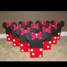 a group of red and black minnie mouse cupcakes with bows on their heads