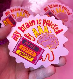 My brain is powered by AAAs, ADHD, autism and anxiety. Funny original design sticker, perfect for AUDHD, ADHD, Autistic and anxious people (designed by us, who have all three! yay!) Stick your sticker anywhere you like to celebrate who you are or to gift to someone to show you are proud of their neurodivergent identity. This sticker is perfect to stick most places due to its large size and weatherproof coating. A few suggestions include sticking it on your laptop, your water bottle, a note book, in your scrapbook. The possibilities are endless and it is the best way to make a statement.  The sticker is approx 8cm x 8cm in size size and Weather proof, therefore you don't have to worry about your sticker smudging if it gets wet. For lots more stickers as well as gay jewellery, art and more v Meme Stickers, Note Book, Design Sticker, My Brain, Free Stickers, Sticker Art, Cute Stickers, Original Design, Sticker Design