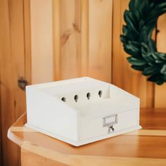 a white box sitting on top of a wooden table