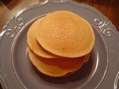 three pancakes sitting on top of a blue plate