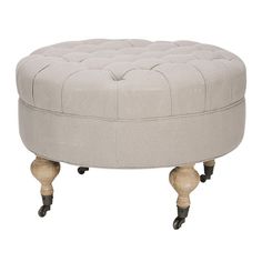 a round ottoman sitting on wheels in front of a white background with the foot rest down