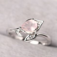 ◆ The ring is handcrafted from sterling silver and decorated with a dazzling 5*7 mm rose quartz and CZs. It is suitable for engagement/anniversary/daily occasion. ◆ Production Description: Main stone Type: Natural Rose Quartz Main Stone Shape: Pear Cut Main Stone Size: 5*7 mm(0.74ct) Side stone: CZ Metal: 925 Sterling silver - Other options available in the drop down menu ◆ Customization: √Free for Add Engraving √Other Metal Type Available √Other Gemstones & Shapes Available √Personalization Ruby And Rose Quartz Ring, Elegant Pink Flower Ring For Anniversary, Pink Rose Quartz Rings For Anniversary, Pink Rose Quartz Anniversary Rings, Elegant Pink Rose Quartz Crystal Ring, Pink Rose Quartz Wedding Rings, Rose Sterling Silver Wedding Rings, Wedding Crystal Ring With Rose Quartz Gemstone, Wedding Rings In Rose Sterling Silver