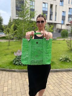 Introducing our stylish knitted summer bag, a perfect blend of elegance and practicality for young women and girls. This charming green bag is meticulously handcrafted using high-quality yarn, ensuring a durable and fashionable accessory that will complement any summer outfit. Designed with a short handle, this bag is ideal for casual outings, beach trips, or any occasion where you want to carry your essentials in style. The intricate crochet patterns create a beautiful texture, adding depth and Green Square Straw Bag For Vacation, Trendy Green Beach Bag With Braided Handles, Summer Green Bags With Braided Handles, Green Rectangular Shoulder Bag For Summer, Green Crochet Tote Straw Bag, Green Crochet Beach Bag For Daily Use, Trendy Green Straw Shopping Bag, Green Crochet Bag For Daily Use In Spring, Green Crochet Straw Tote Bag