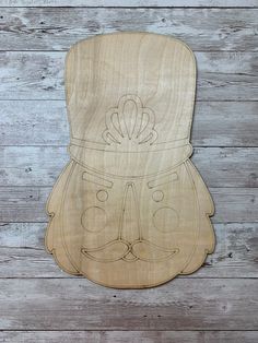 a wooden cutting board with an image of a man's face