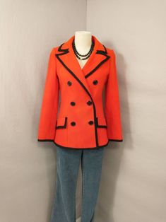 "Vibrant red wool jacket with black trim. Classic styling. Button front. Great for holiday wear. Condition is good, no excess wear but - has fading back of right sleeve and many marks. May improve with dry cleaning but no odor and may have been attempted already. Label is French Shop. Super quality. Circa early eighties. Shown on an 6 mannequin. Measurements - Length 27\" Shoulder 16\" Bust 36/37\" Waist 32\" Hem circumference 43\" Sleeve length 24.5\" Wt 2.5lbs 3 to ship" Classic Blazer With Contrast Trim For Fall, Classic Fall Blazer With Contrast Trim, Tailored Outerwear With Contrast Trim For Fall, Fitted Fall Outerwear With Contrast Trim, Fitted Outerwear With Contrast Trim For Fall, Office Outerwear With Contrast Trim For Fall, Fall Office Outerwear With Contrast Trim, Fall Blazer With Contrast Trim And Long Sleeves, Fitted Vintage Red Outerwear