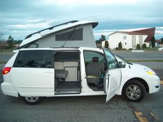 a small white van with its door open